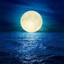 Full moon over a lake illuminating the sky at night