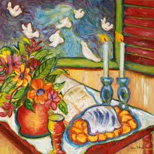 Shabbat Table set with lit candles and challah and flowers in a red vase with doves flying around it