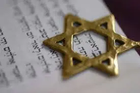 gold Magen David sitting on a Chumash