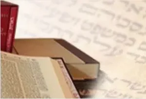 Stack of Torah books on top of Torah text