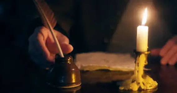 Man writing with a feather on a scroll by candle light