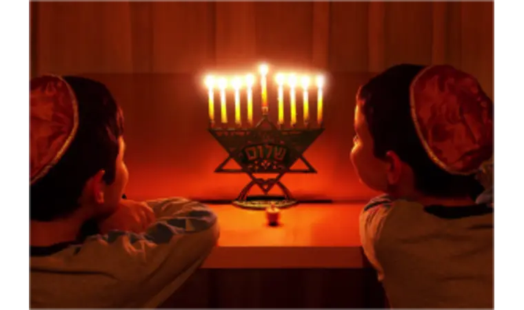 Boys watching the Chanukah candles burn