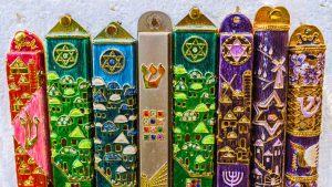 Row of different colorful mezuzah's with different designs