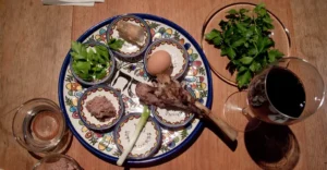 A filled seder plate with shank bone, egg, parsley, charoset, and maror