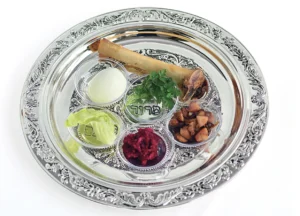 Seder plate with shank bone, egg, charoset, maror, carpas