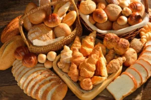 Table with all different types of bread spread out
