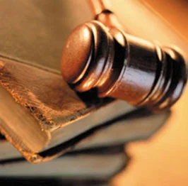 brown mallet on a stack of books on a table