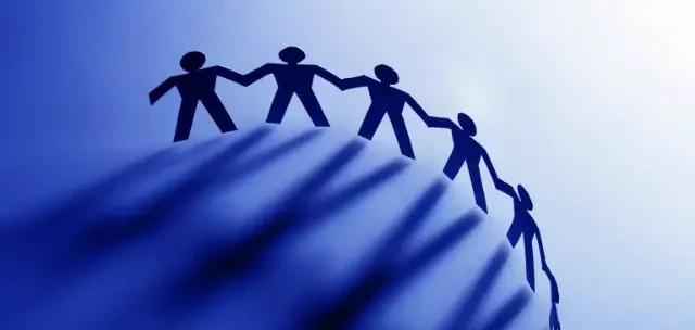 People icons holding hands circling the earth