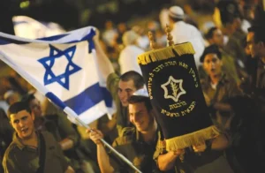 IDF soldiers holding a Sefer Torah and an Israeli flag